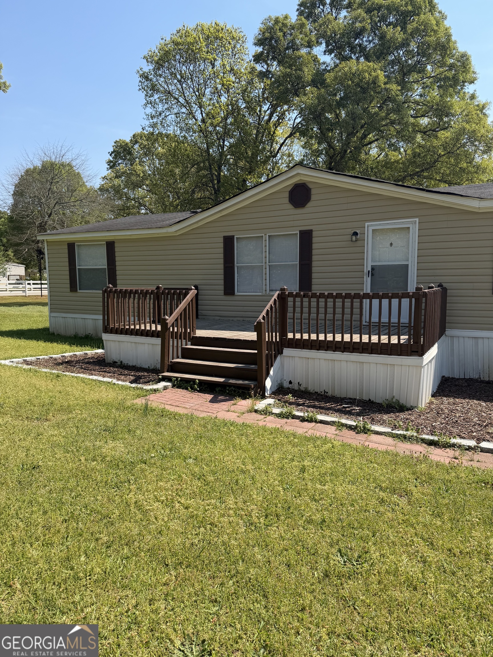 405 Windsor Parkway, Unit 405W Hampton, GA 30228 - Photo 1 of 16 a view of a house with backyard and sitting area