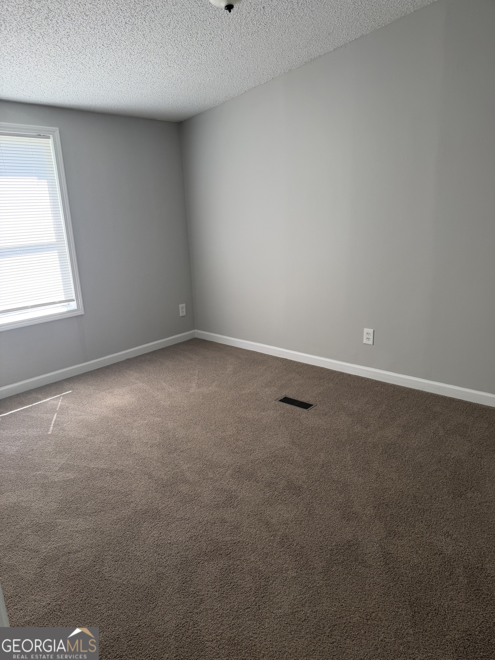 405 Windsor Parkway, Unit 405W Hampton, GA 30228 - Photo 12 of 16 an empty room with a window