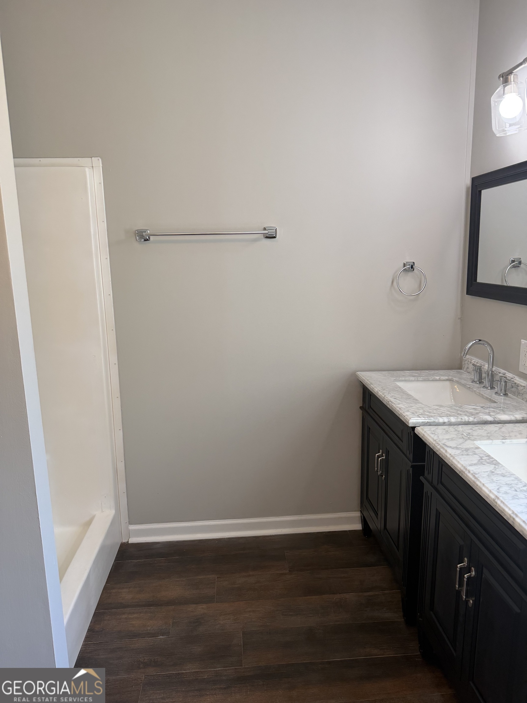 405 Windsor Parkway, Unit 405W Hampton, GA 30228 - Photo 16 of 16 a bathroom with a granite countertop sink and a mirror