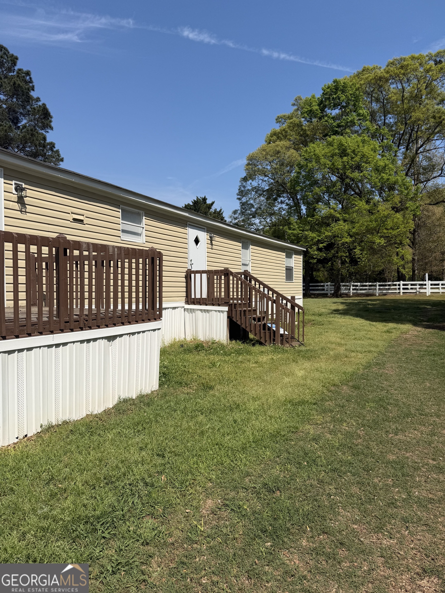 405 Windsor Parkway, Unit 405W Hampton, GA 30228 - Photo 2 of 16 a view of a house with backyard and sitting area