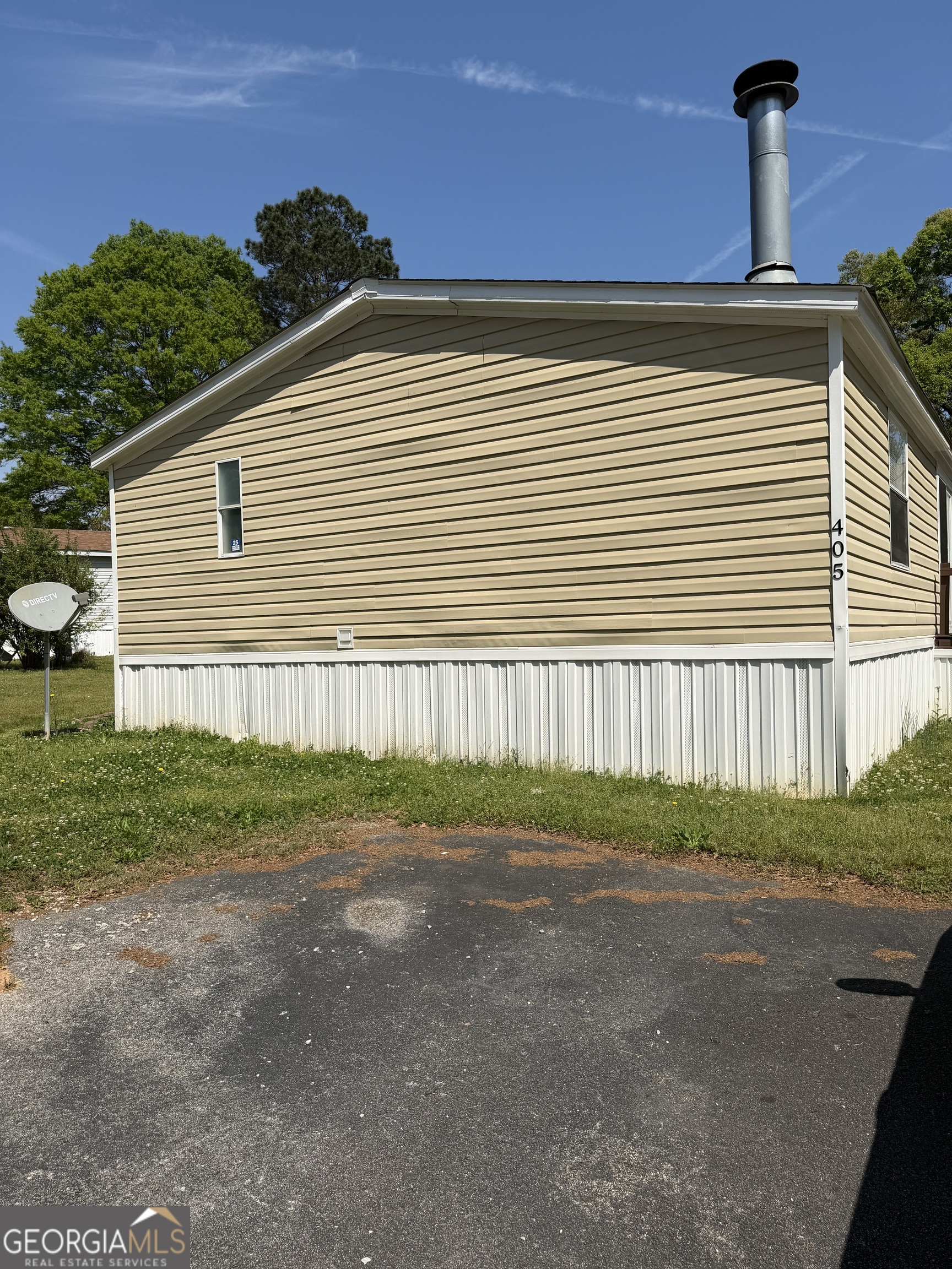405 Windsor Parkway, Unit 405W Hampton, GA 30228 - Photo 3 of 16 a front view of a house with garden