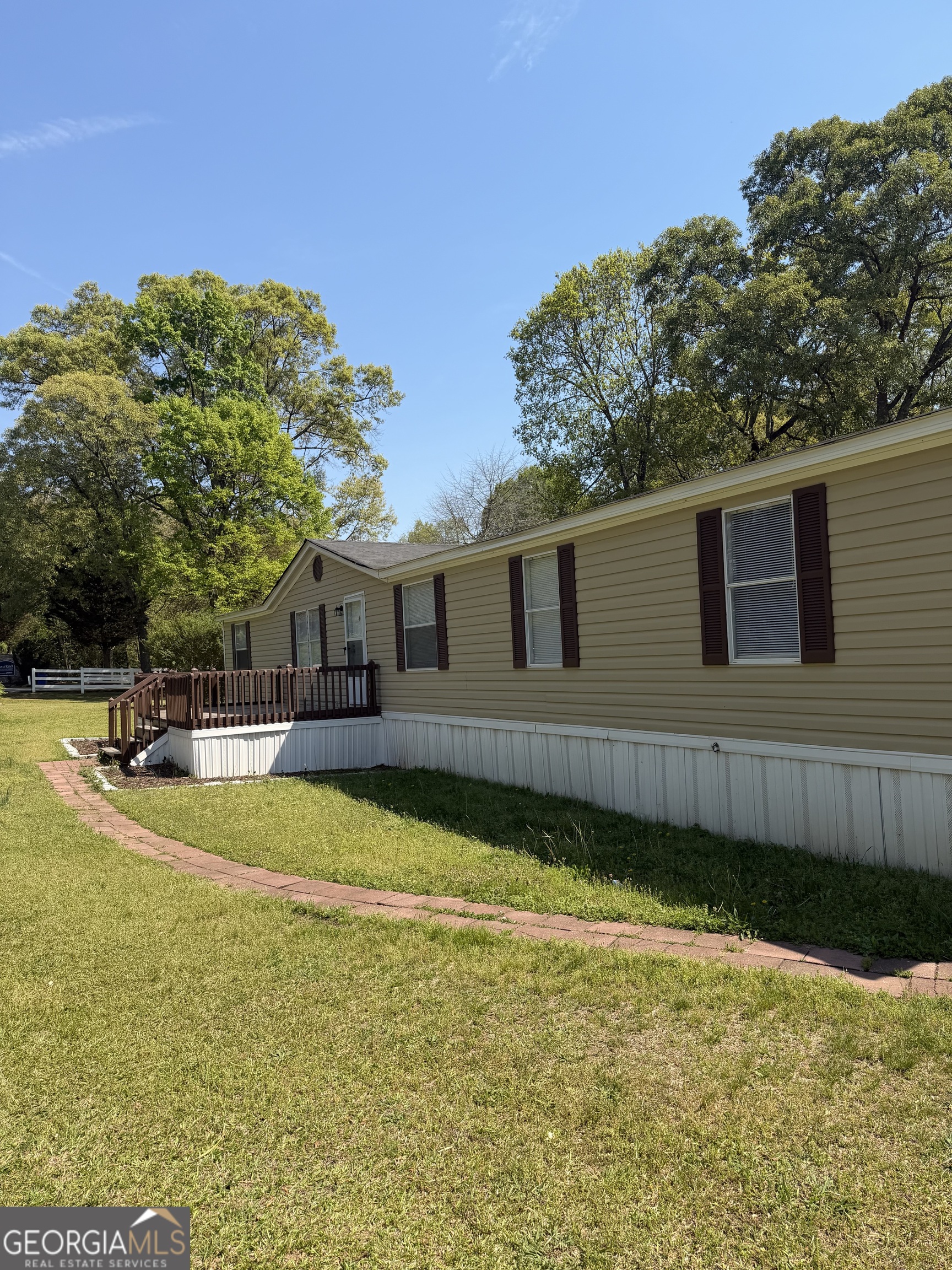 405 Windsor Parkway, Unit 405W Hampton, GA 30228 - Photo 4 of 16 a view of a house with swimming pool next to a yard