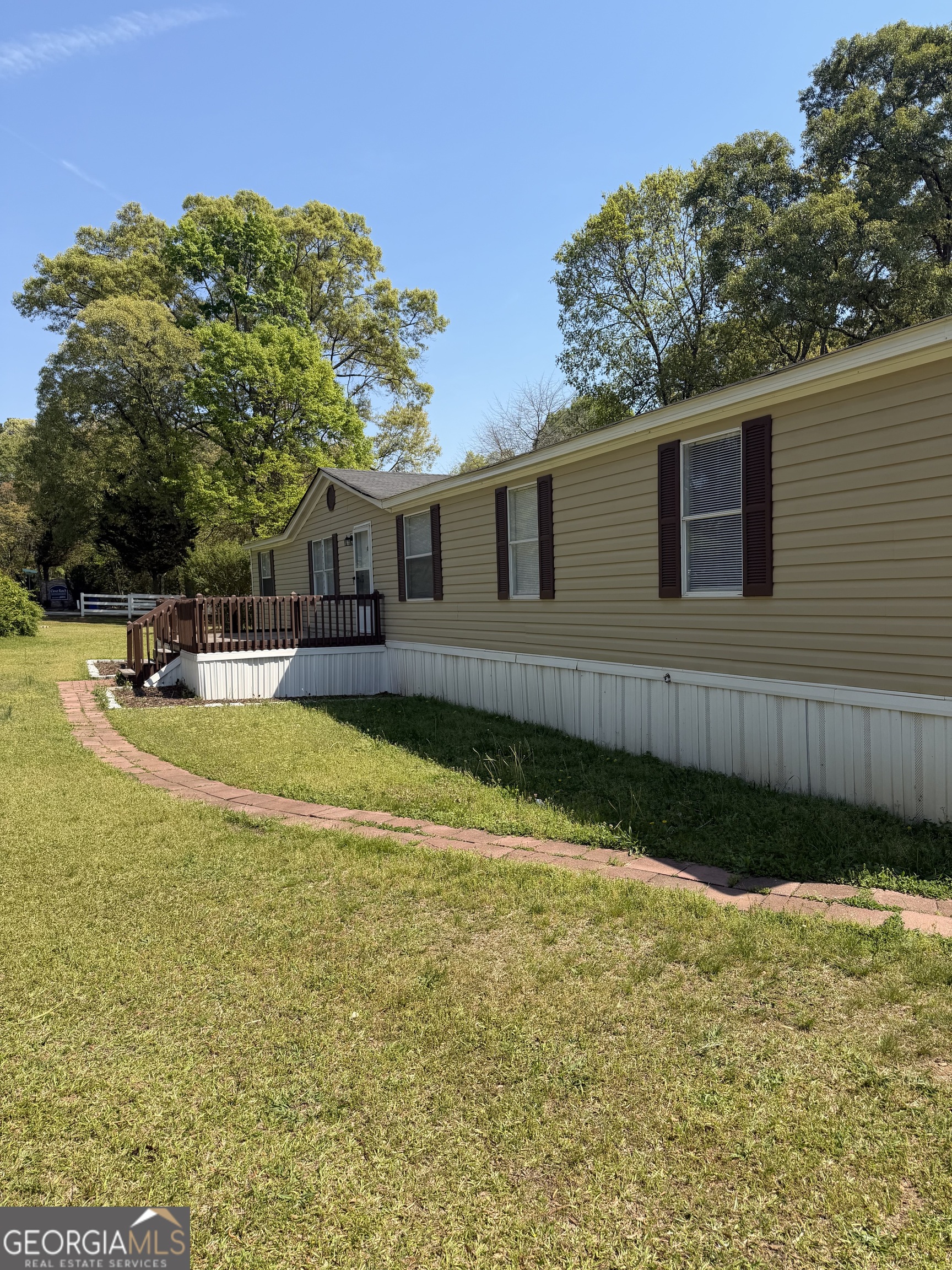 405 Windsor Parkway, Unit 405W Hampton, GA 30228 - Photo 5 of 16 a view of a house with pool and a yard