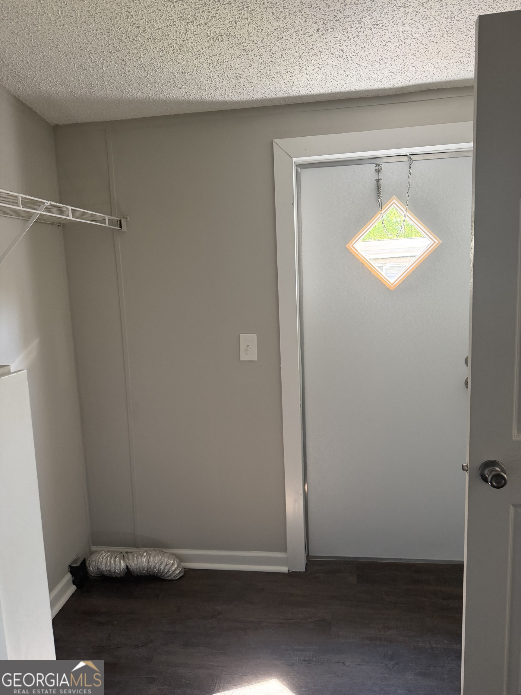 405 Windsor Parkway, Unit 405W Hampton, GA 30228 - Photo 8 of 16 an empty room with wooden floor and windows