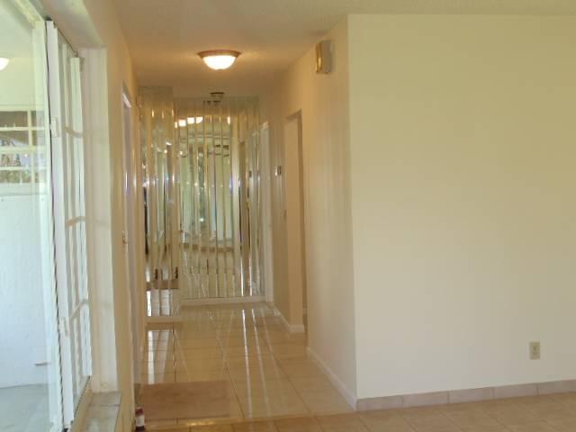 1112 Seagrape Road Lantana, FL 33462 - Photo 5 of 22 a bathroom with a glass shower door