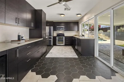 a kitchen with stainless steel appliances granite countertop a stove a sink and a refrigerator