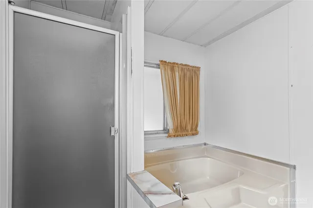 a bath tub sitting next to a window