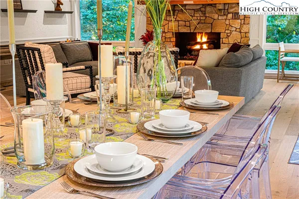 a dining room with furniture and a wooden floor