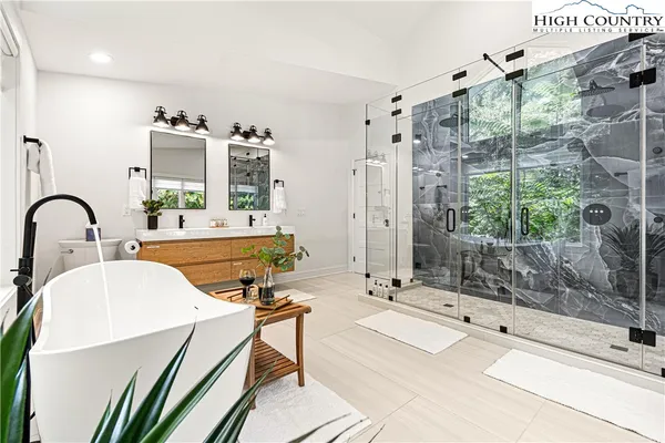 a spacious bathroom with a double vanity sink and a mirror