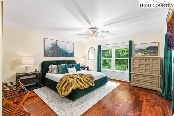 a bedroom with a bed and a large window