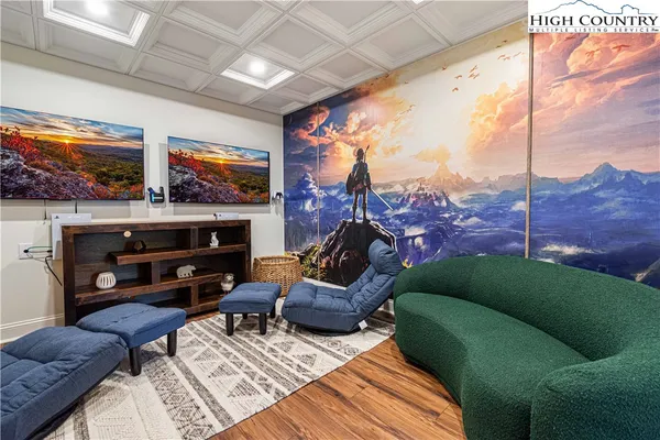 a living room with furniture a flat screen tv and a fireplace