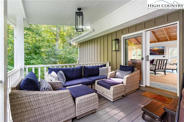 a view of house with swimming pool and furniture