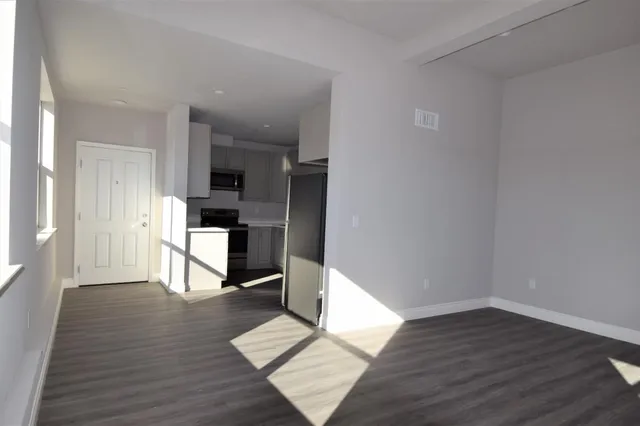 a kitchen with a sink and steel appliances