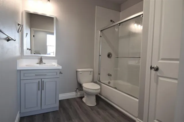 a kitchen with stainless steel appliances a refrigerator and wooden floor