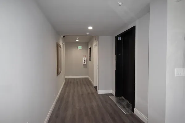 a view of hallway with wooden floor