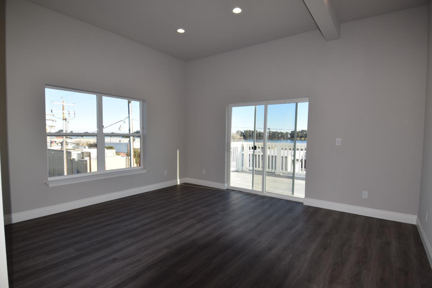 93 South 2nd Street Rio Vista, CA 94571 - Photo 9 of 25 an empty room with wooden floor and windows