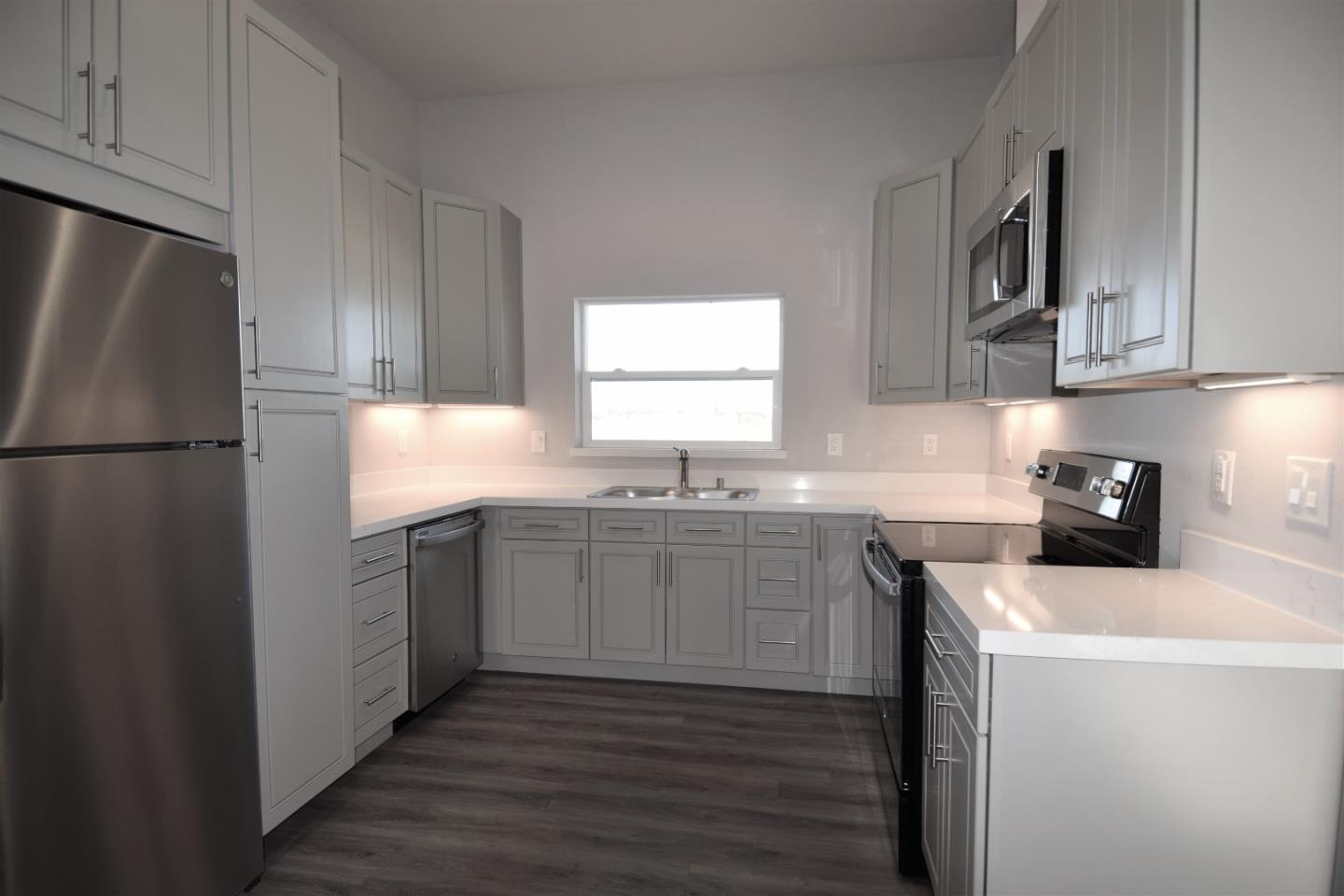 93 South 2nd Street Rio Vista, CA 94571 - Photo 10 of 25 a kitchen with a sink a refrigerator a microwave and cabinets