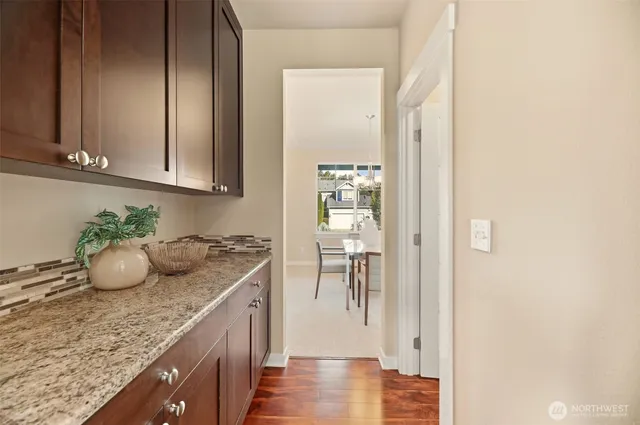 a kitchen with granite countertop a sink and a stove