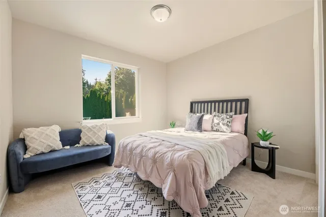 a bedroom with a bed and a couch