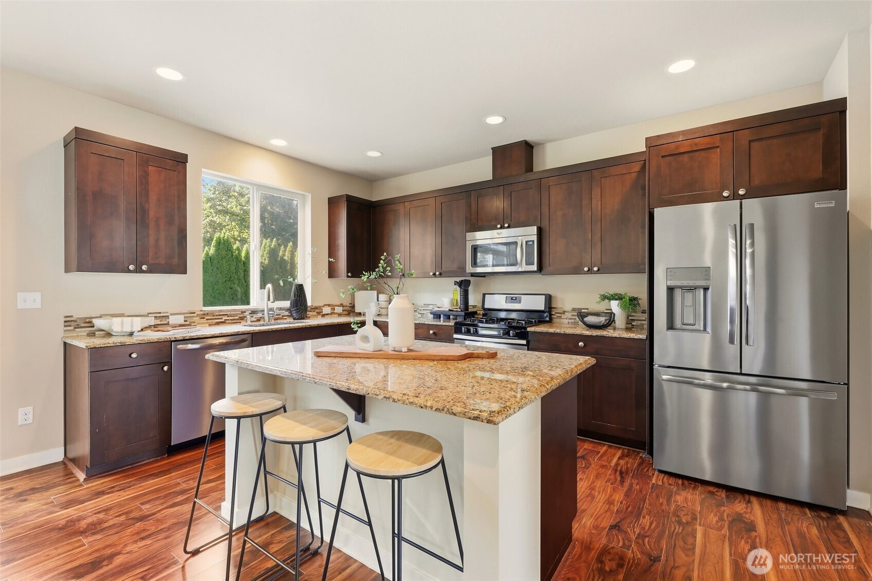 816 218th Street Southeast Bothell, WA 98021 - Photo 2 of 3 a kitchen with stainless steel appliances granite countertop a refrigerator a sink dishwasher a stove and white countertops with wooden floor
