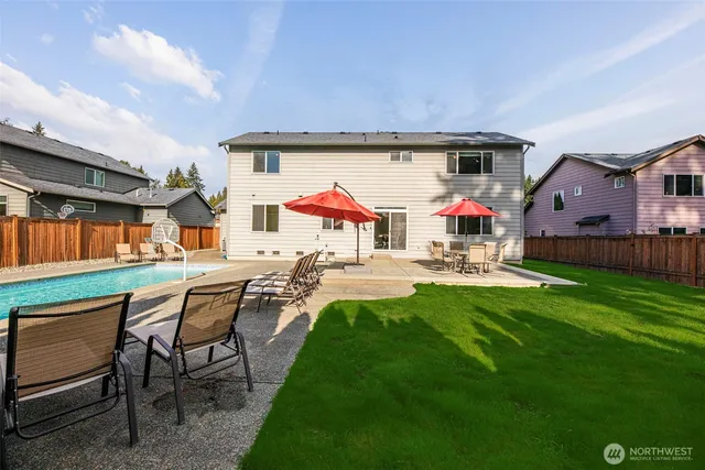 a view of patio with table and chairs and potted plants with wooden fence