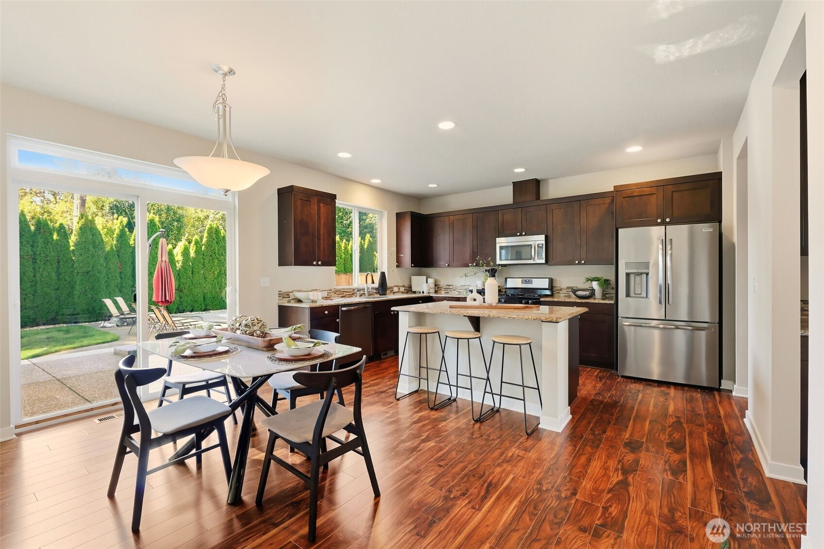 816 218th Street Southeast Bothell, WA 98021 - Photo 10 of 34 a kitchen with a table chairs refrigerator and microwave