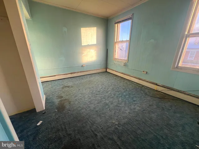 an empty room with windows and closet