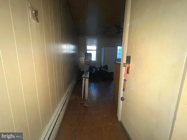 a kitchen with stainless steel appliances granite countertop a refrigerator a sink dishwasher a dining table and chairs with wooden floor