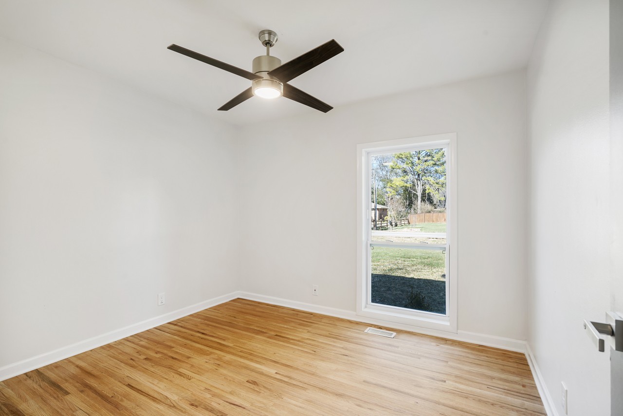 209 Stable Road Franklin, TN 37069 - Photo 19 of 25 an empty room with wooden floor fan and windows