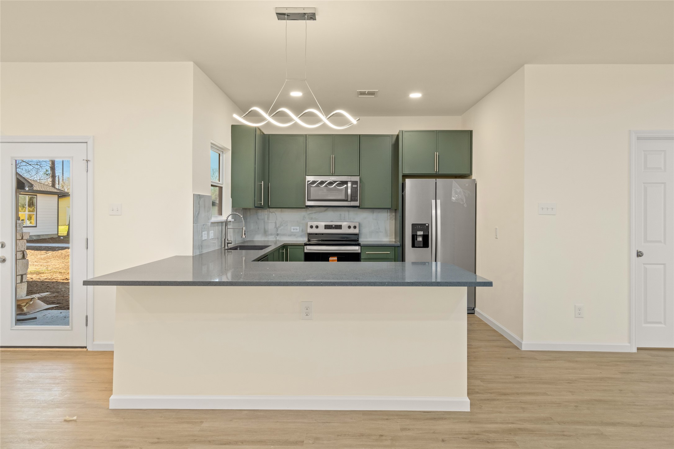4656 North Teague Street Rosharon, TX 77583 - Photo 12 of 41 Spacious kitchen island anchors the heart of the home—perfect for hosting.