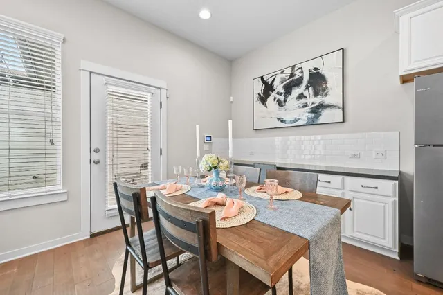 a view of a dining room with furniture and wooden floor