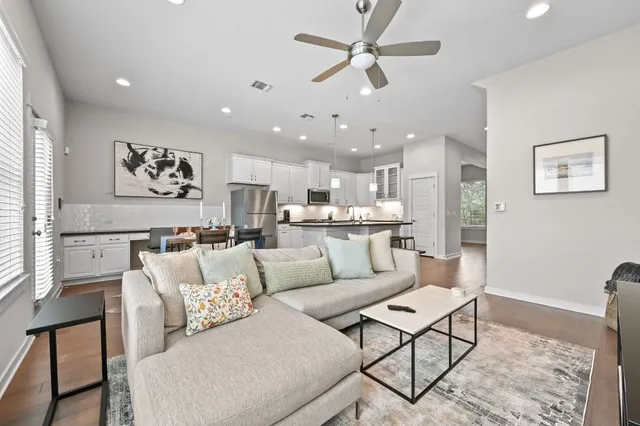 a living room with furniture and a chandelier