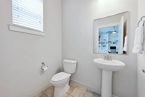 a bathroom with a sink toilet and a mirror