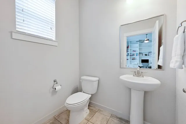 a bathroom with a sink toilet and a mirror