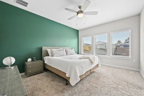 a spacious bedroom with a bed and window