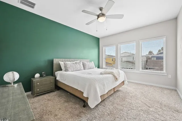 a spacious bedroom with a bed and window