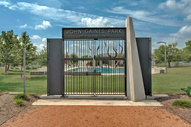 a view of a entrance gate of the house and trees