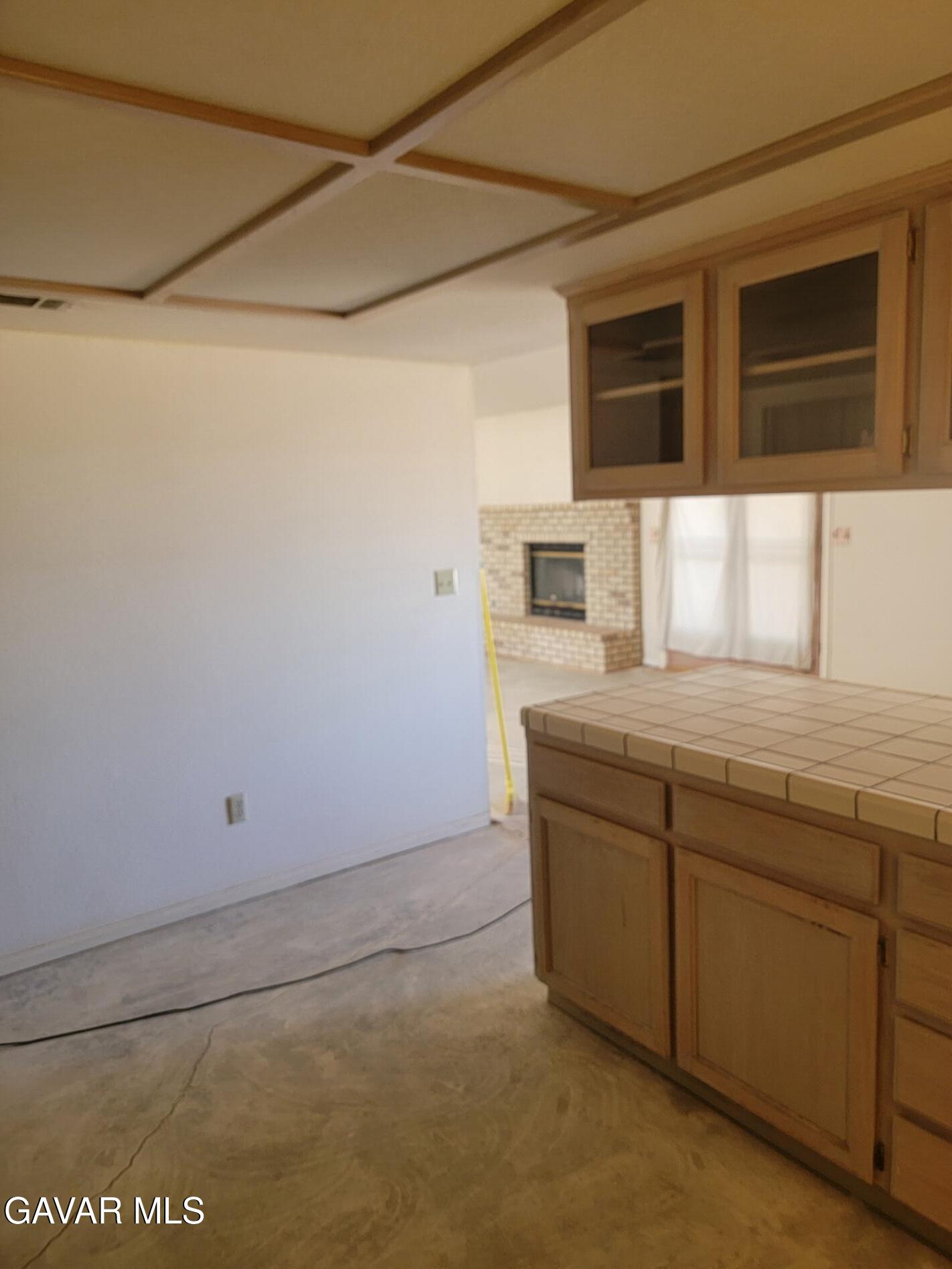 21481 Randsburg Mojave Road California City, CA 93505 - Photo 16 of 28 a bathroom with a granite countertop sink and washing machine