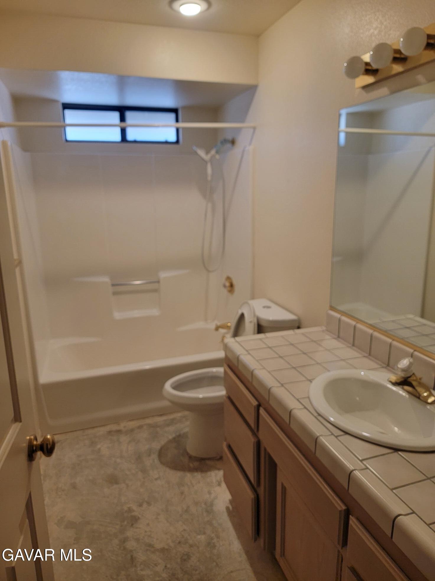 21481 Randsburg Mojave Road California City, CA 93505 - Photo 20 of 28 a bathroom with a granite countertop sink toilet and shower