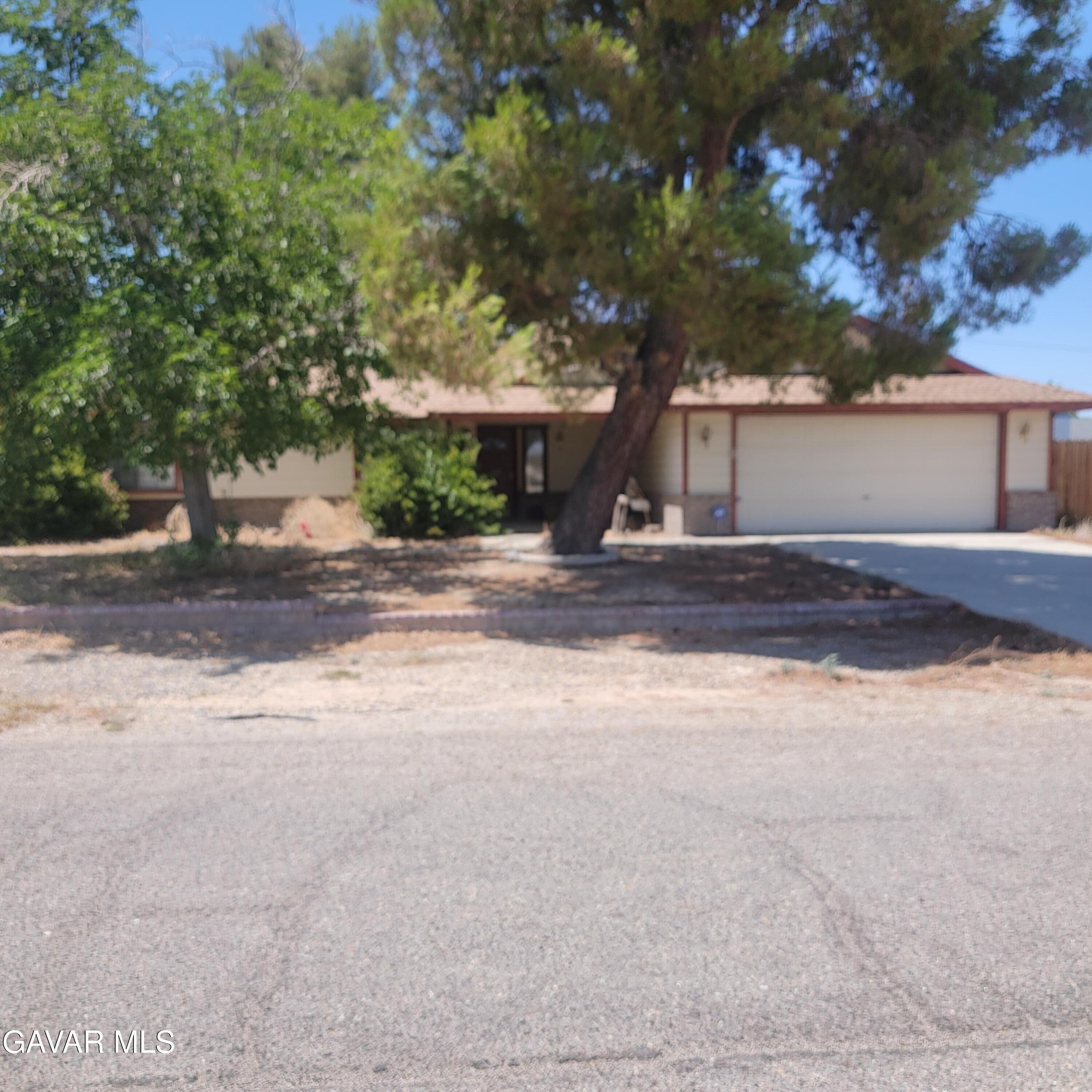 21481 Randsburg Mojave Road California City, CA 93505 - Photo 2 of 28 a view of a house with a yard and large tree