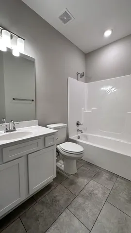 a kitchen with granite countertop white cabinets and stainless steel appliances