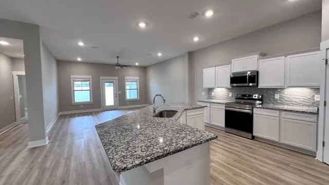 a view of an empty room with a ceiling fan