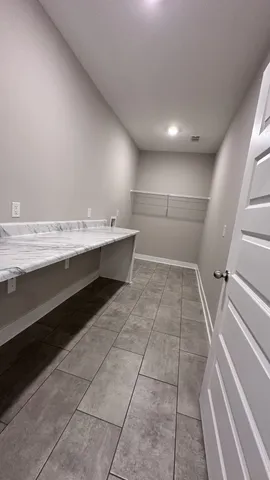 en empty room with windows and ceiling fan