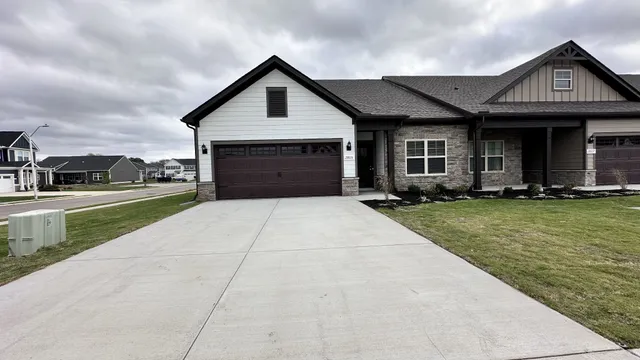 a front view of house with yard and garage