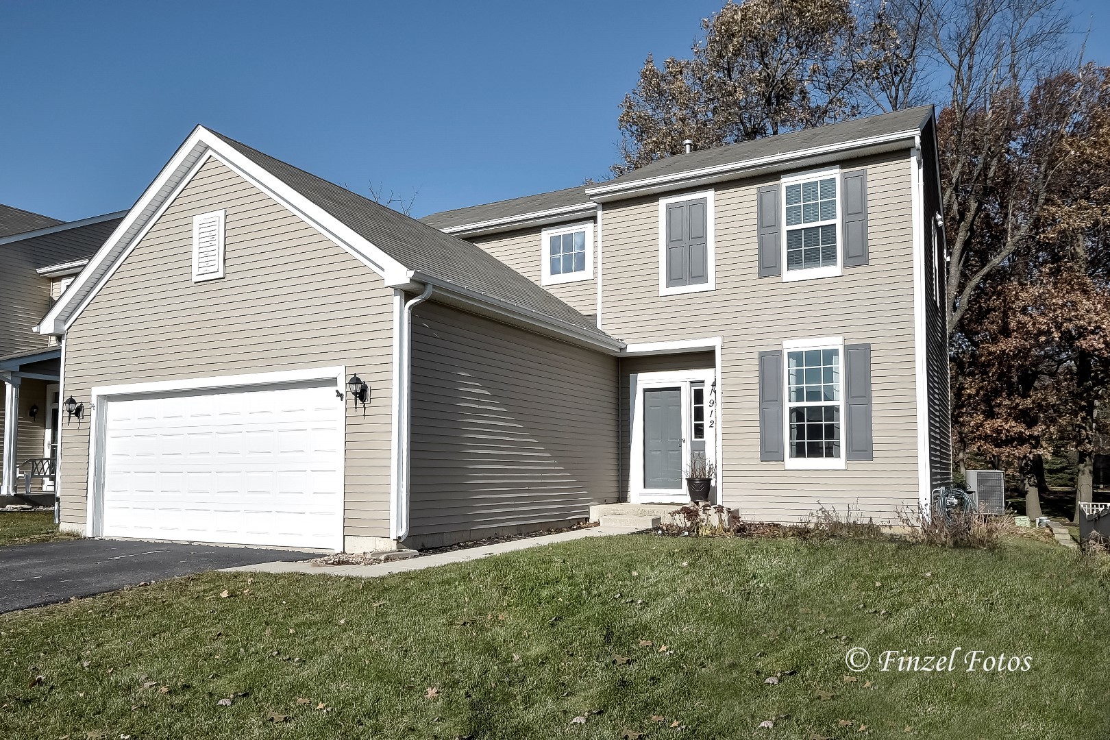 1912 Roger Road Woodstock, IL 60098 - Photo 1 of 21 a front view of a house with a yard