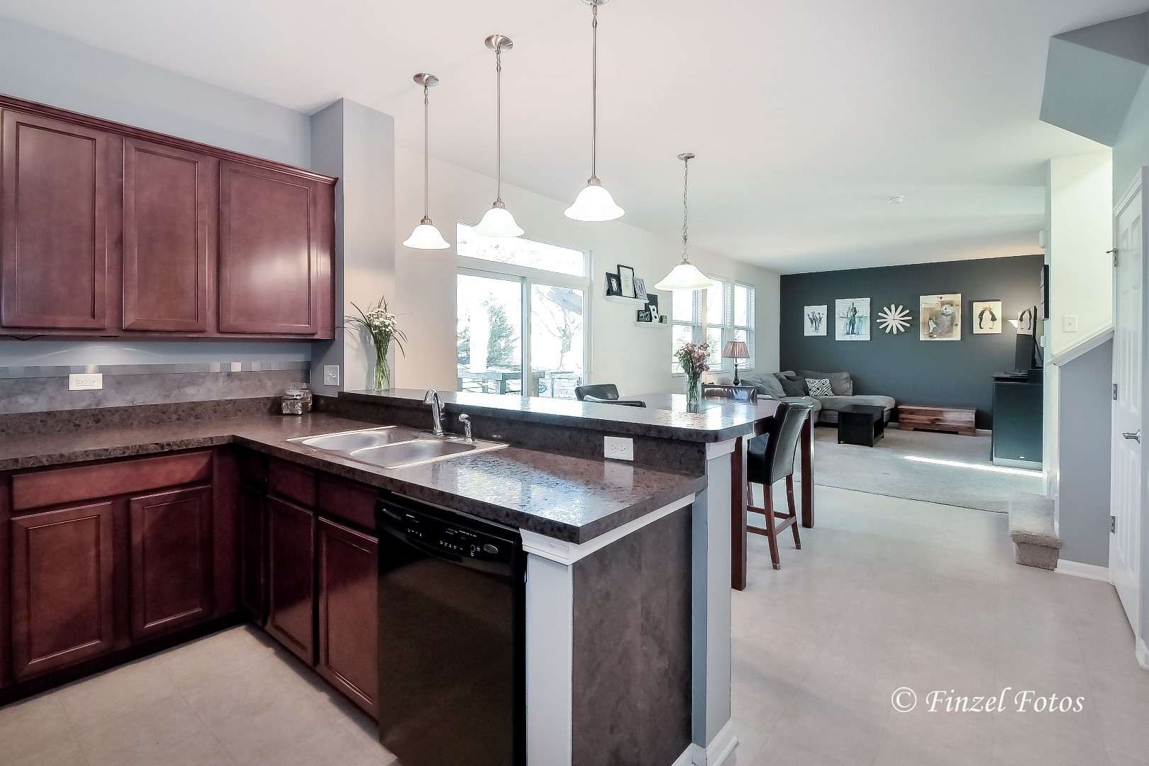 1912 Roger Road Woodstock, IL 60098 - Photo 3 of 21 a kitchen with granite countertop a sink a counter space cabinets and appliances