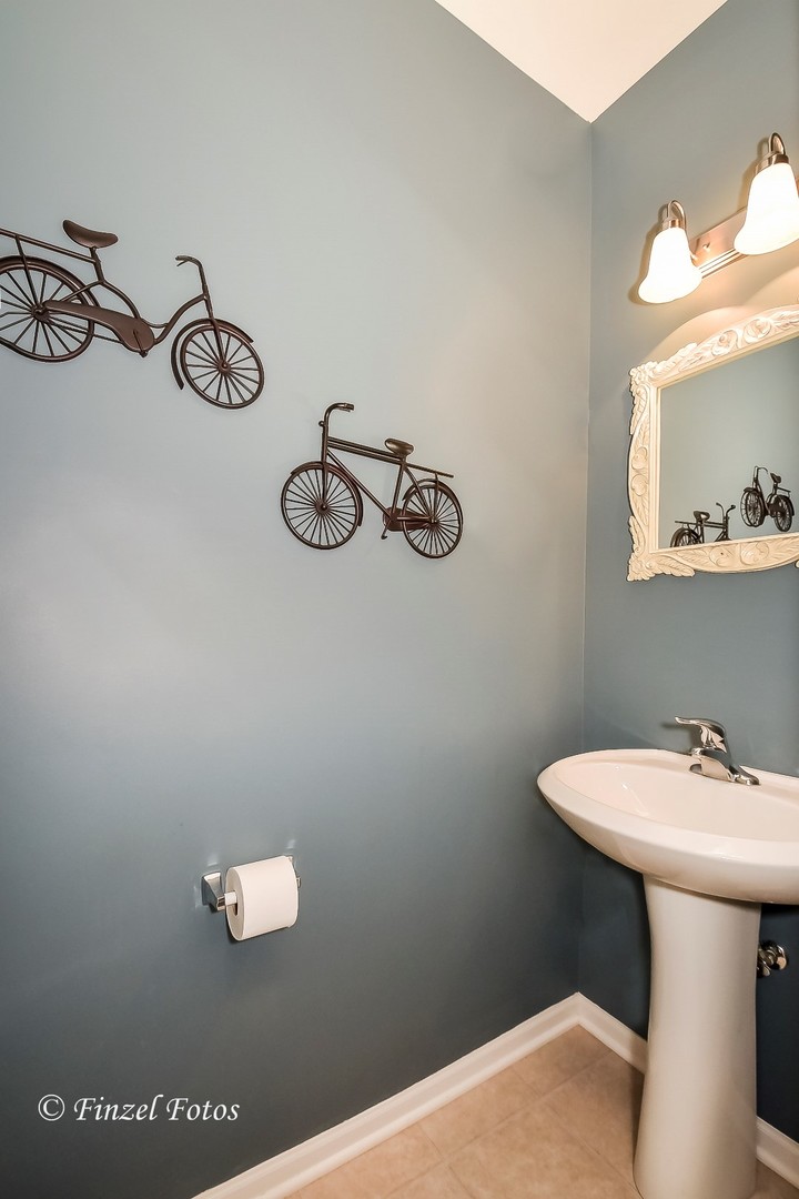 1912 Roger Road Woodstock, IL 60098 - Photo 9 of 21 a bathroom with a sink and mirror