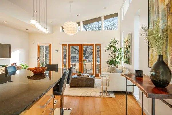 a living room with furniture and floor to ceiling window