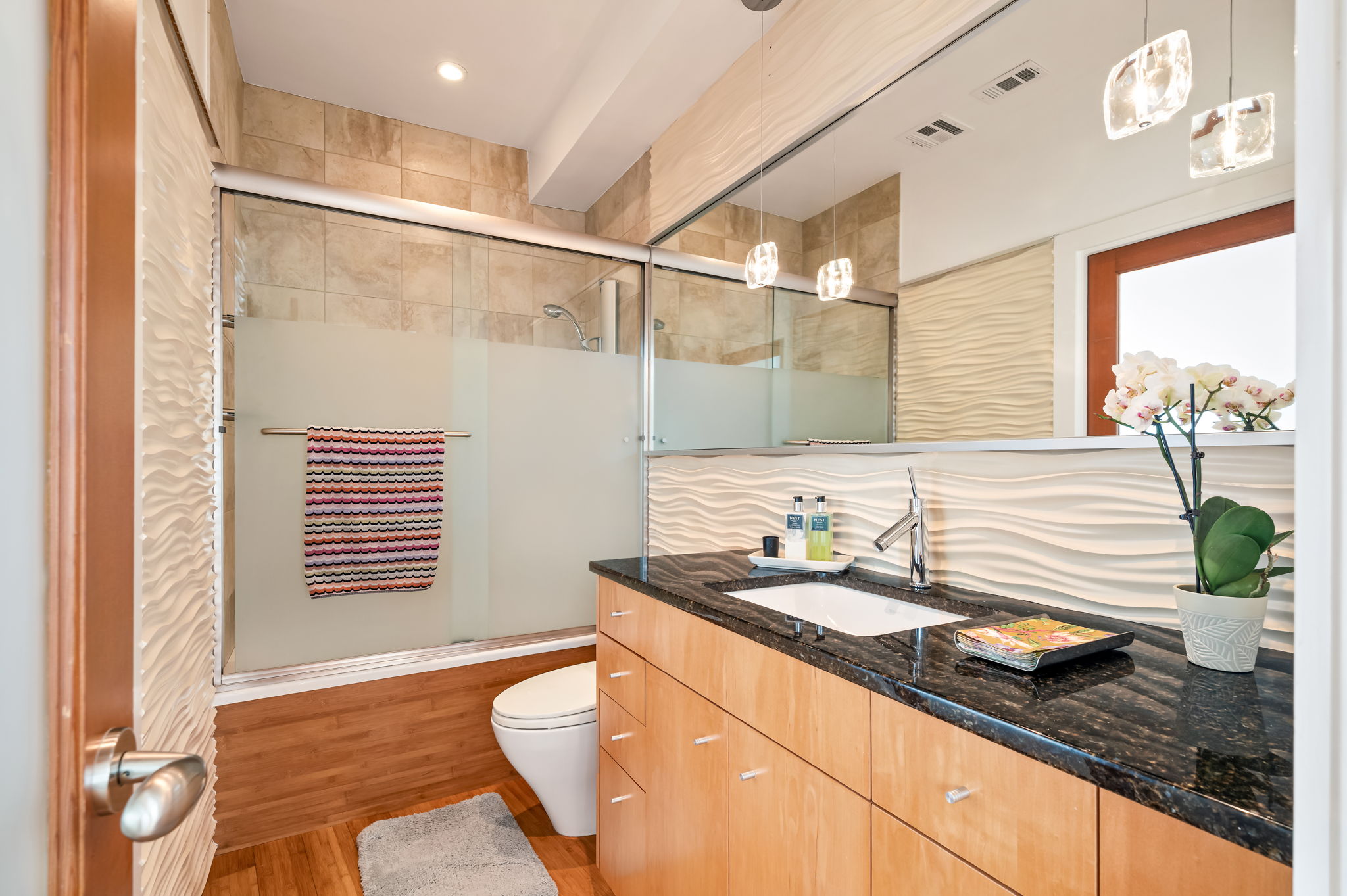 1700 Ravey Street, Unit A Austin, TX 78704 - Photo 17 of 40 Bathroom featuring vanity, enclosed tub / shower combo, light wood-type flooring, and recessed lighting