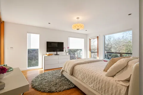 a bedroom with a bed and a flat screen tv